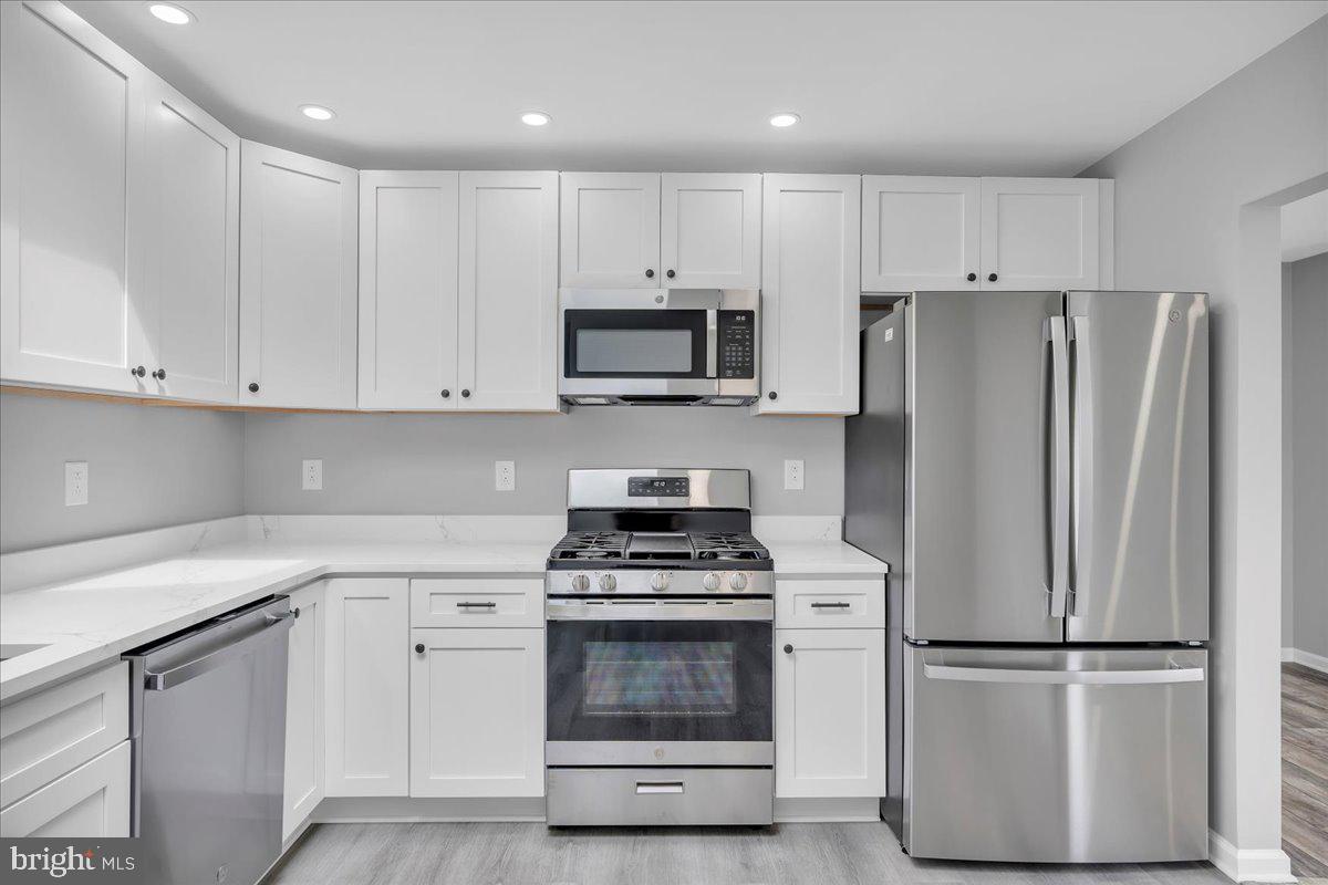 147 Country Club Road Pine Hill, NJ 08021 - Photo 33 of 53 a kitchen with cabinets stainless steel appliances and a counter space