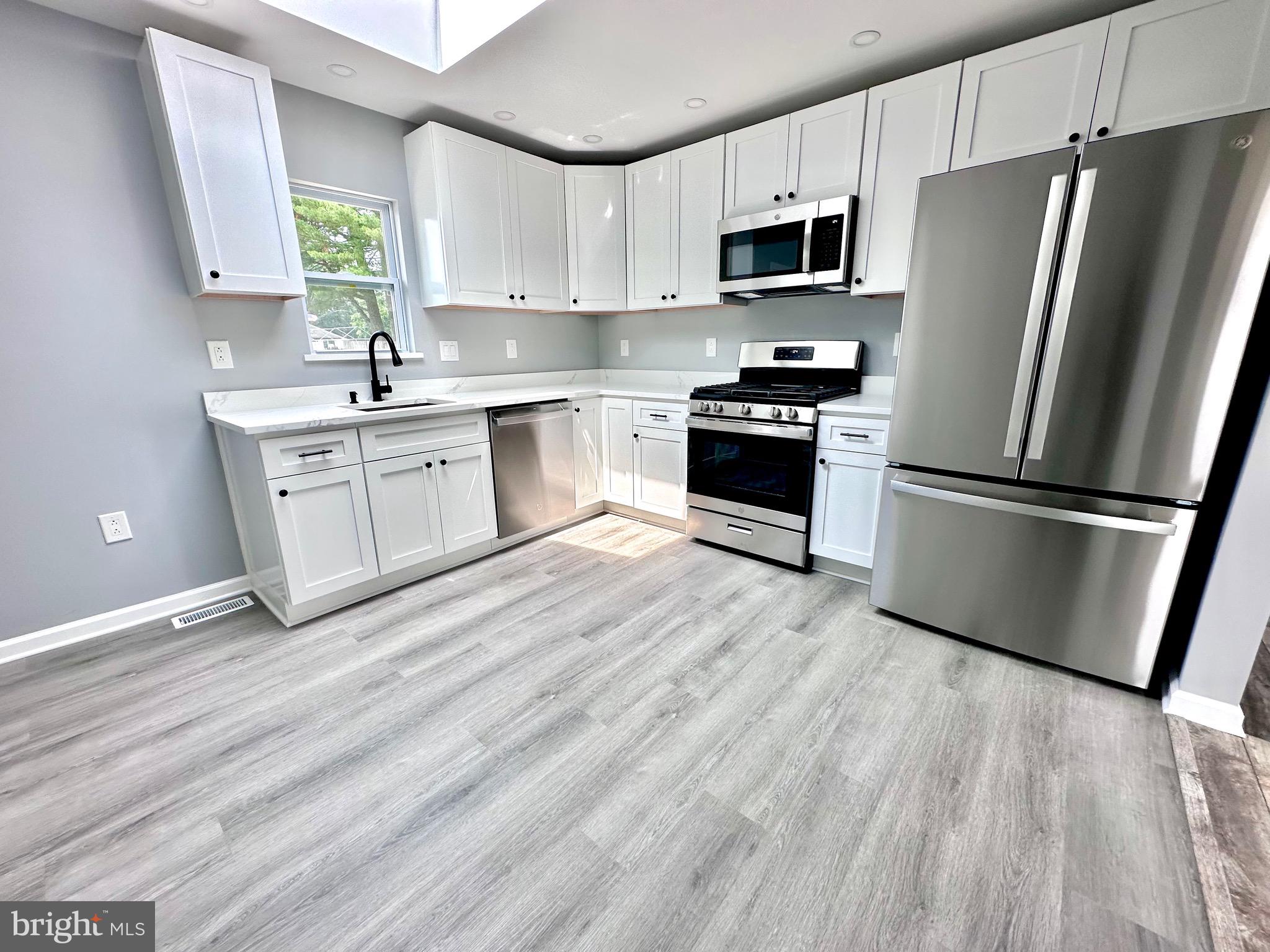 147 Country Club Road Pine Hill, NJ 08021 - Photo 4 of 53 a kitchen with a refrigerator stove and sink