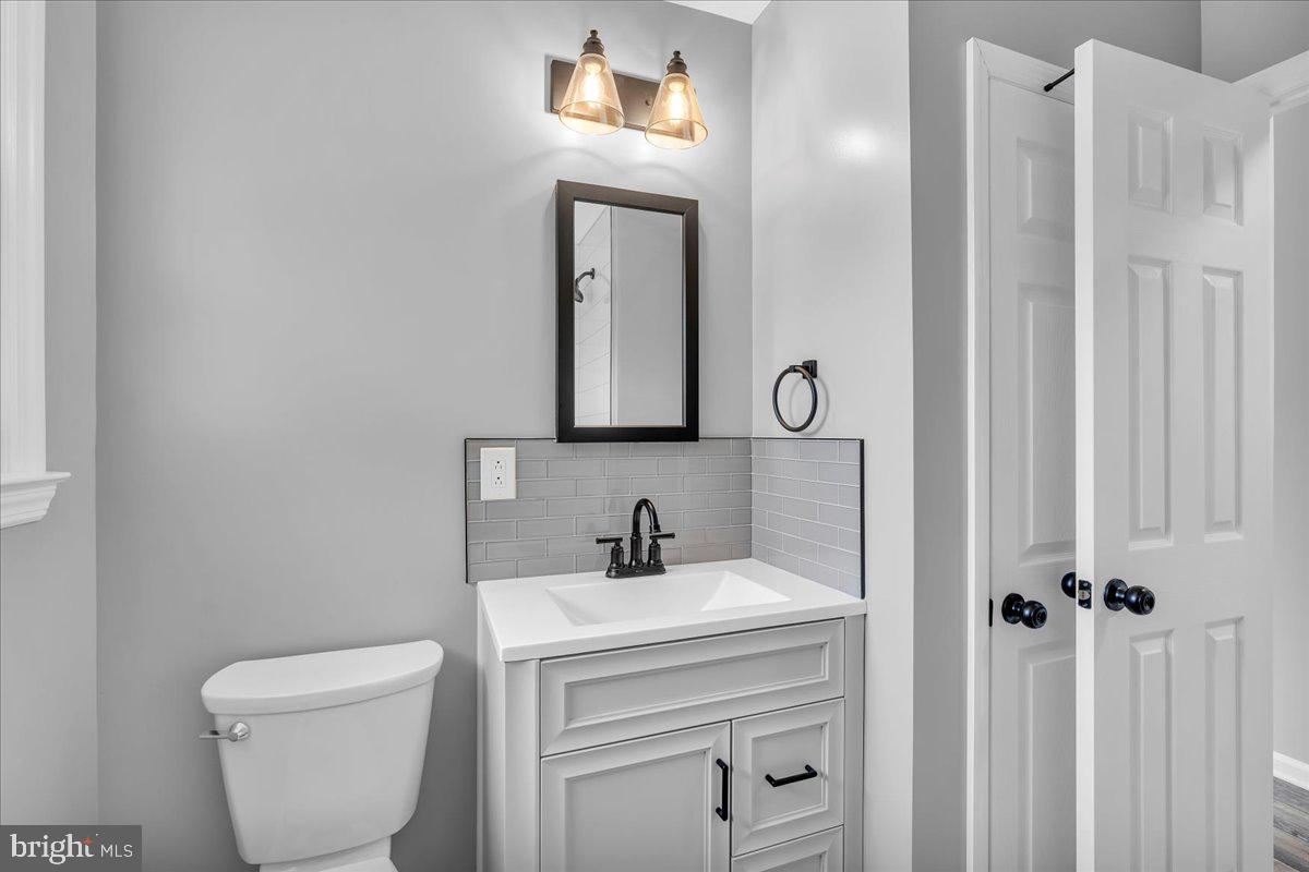 147 Country Club Road Pine Hill, NJ 08021 - Photo 47 of 53 a bathroom with a toilet a sink and mirror