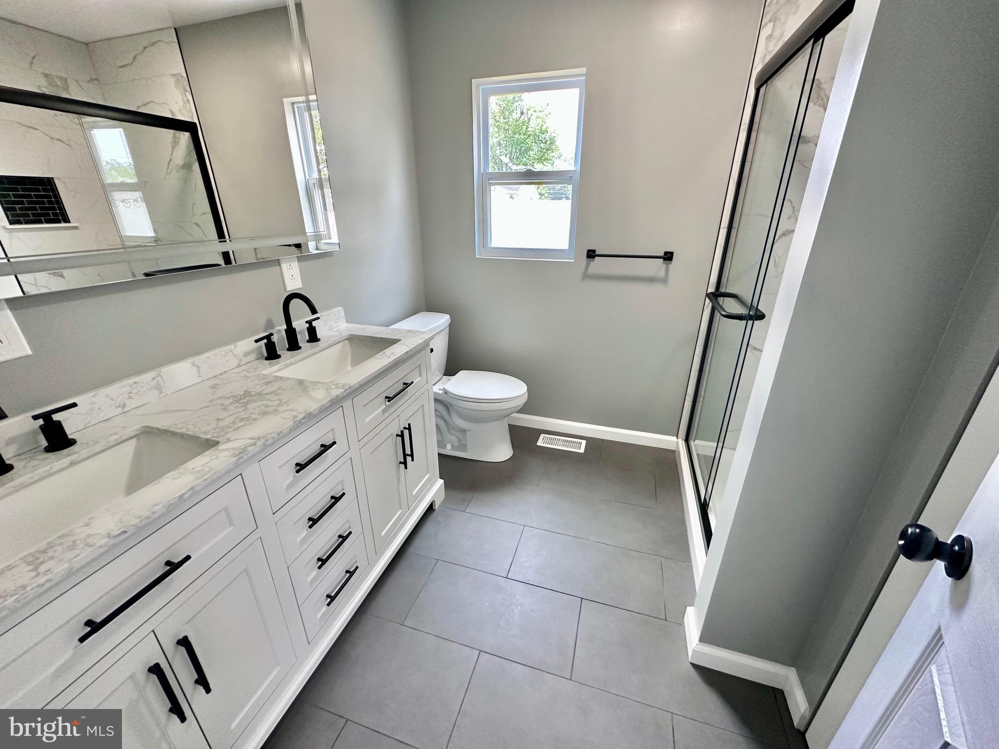 147 Country Club Road Pine Hill, NJ 08021 - Photo 6 of 53 a spacious bathroom with a double vanity sink a mirror and a toilet