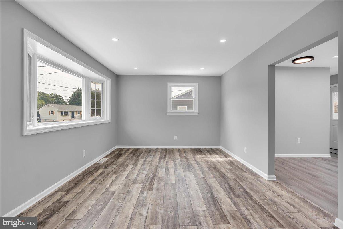 147 Country Club Road Pine Hill, NJ 08021 - Photo 8 of 53 a view of an empty room with wooden floor and a window