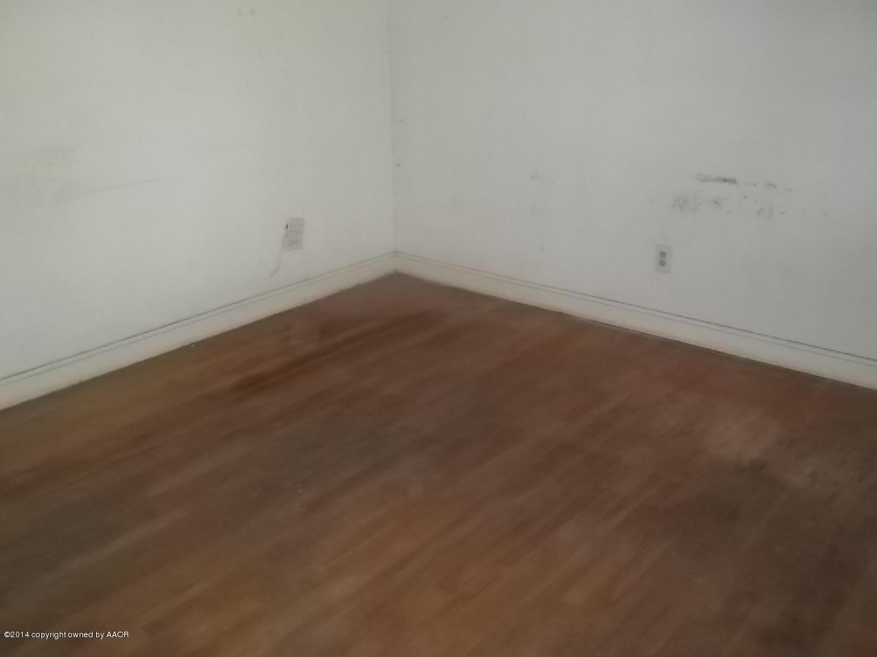 5104 Arden Road Amarillo, TX 79110 - Photo 4 of 9 an empty room with wooden floor