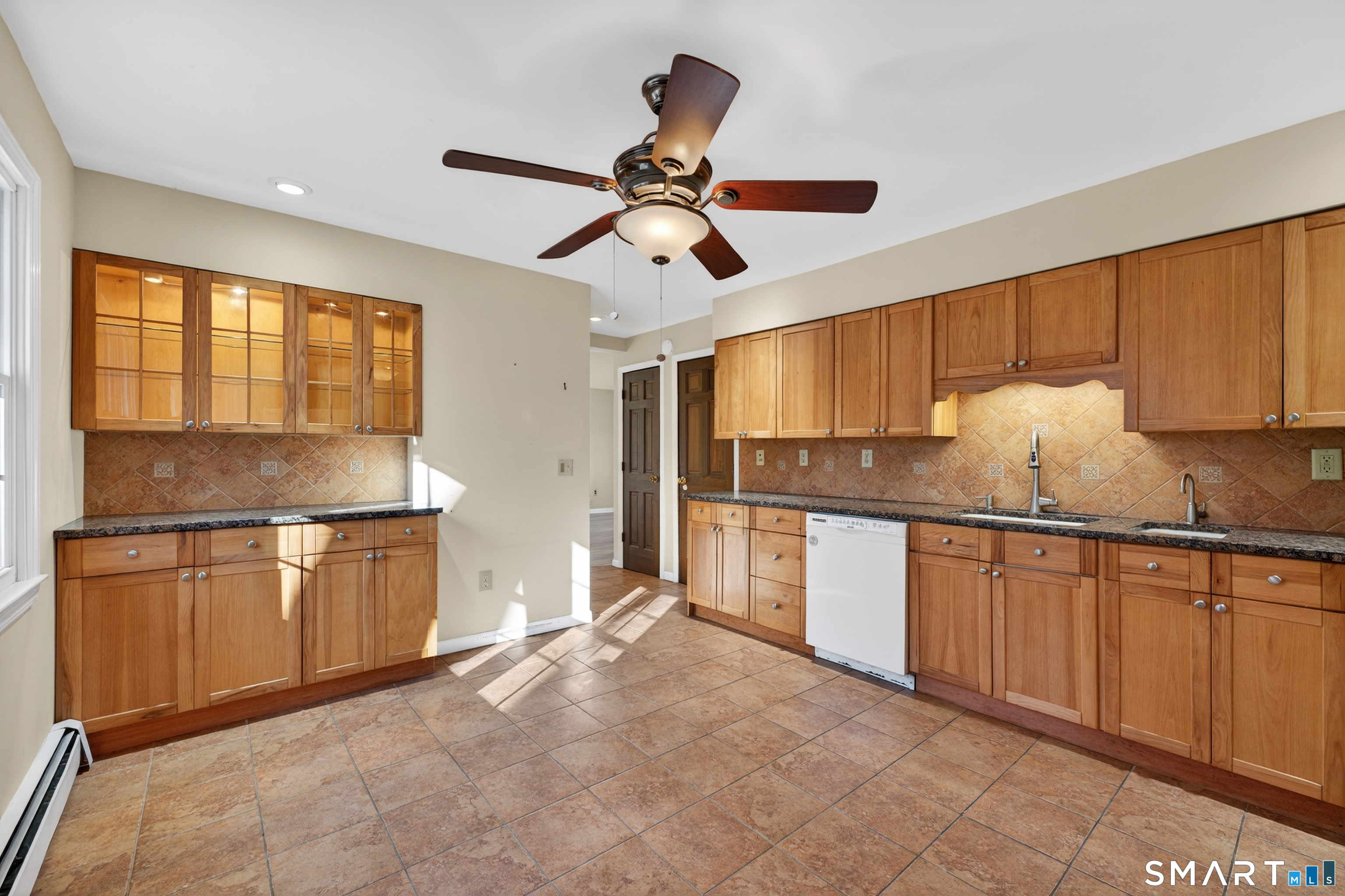 29 Legendary Road East Lyme, CT 06333 - Photo 12 of 36 a kitchen with granite countertop a refrigerator a sink and white cabinets