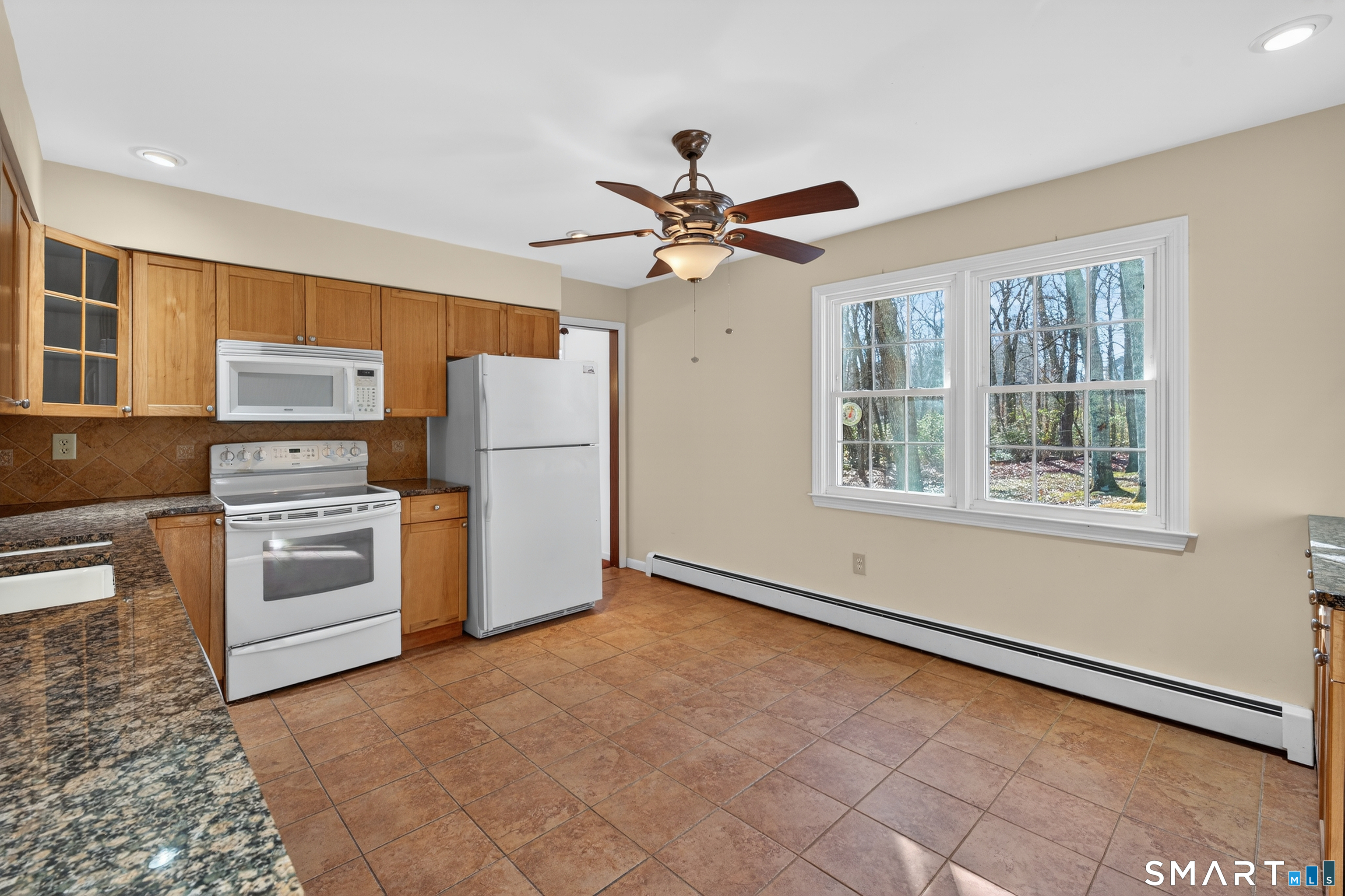 29 Legendary Road East Lyme, CT 06333 - Photo 14 of 36 a kitchen with granite countertop a refrigerator a stove a microwave and island
