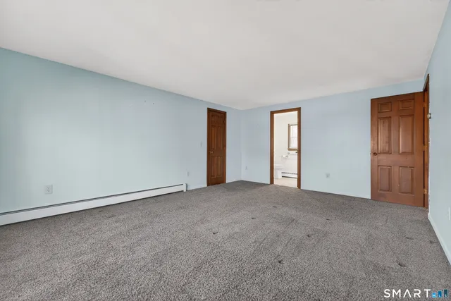 a view of an empty room and closet area