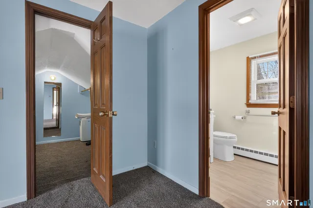 a bathroom with a glass door shower and a bathroom