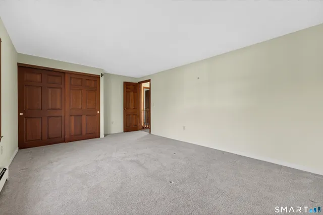 a view of an empty room and closet area