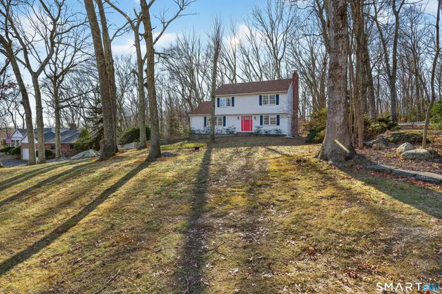a view of a house with a yard covered in snow