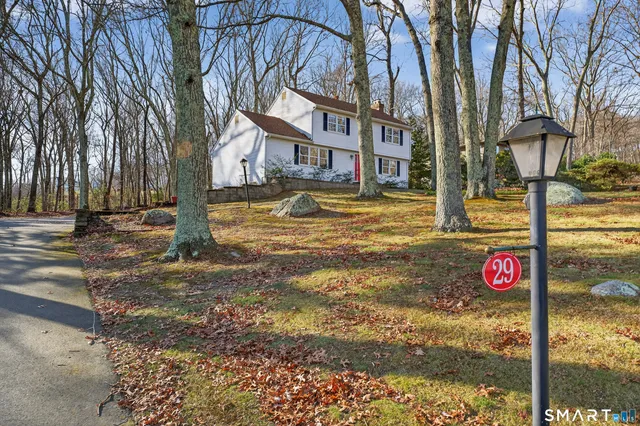 a street sign on a sidewalk next to a road