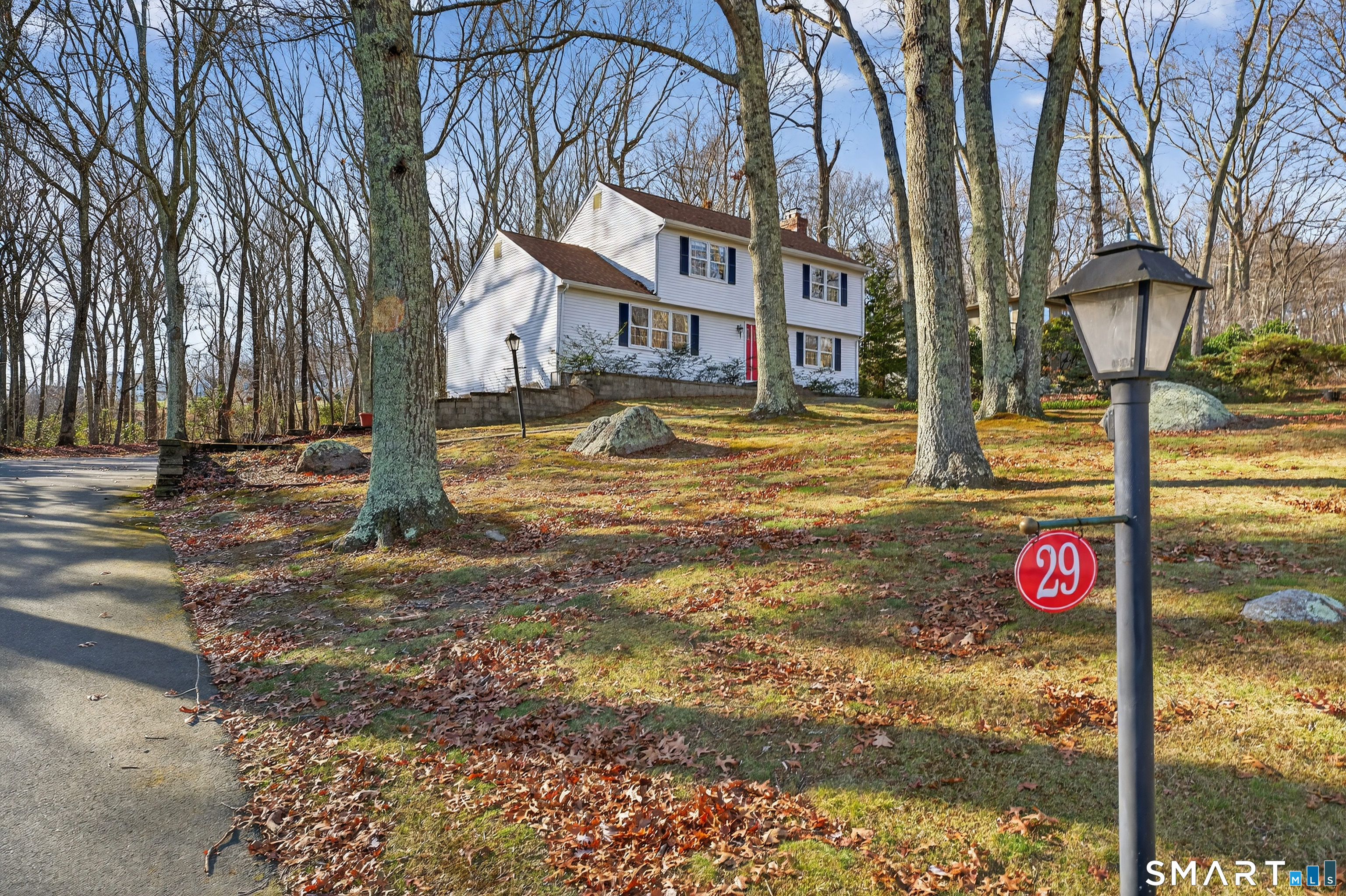 29 Legendary Road East Lyme, CT 06333 - Photo 5 of 36 a street sign on a sidewalk next to a road