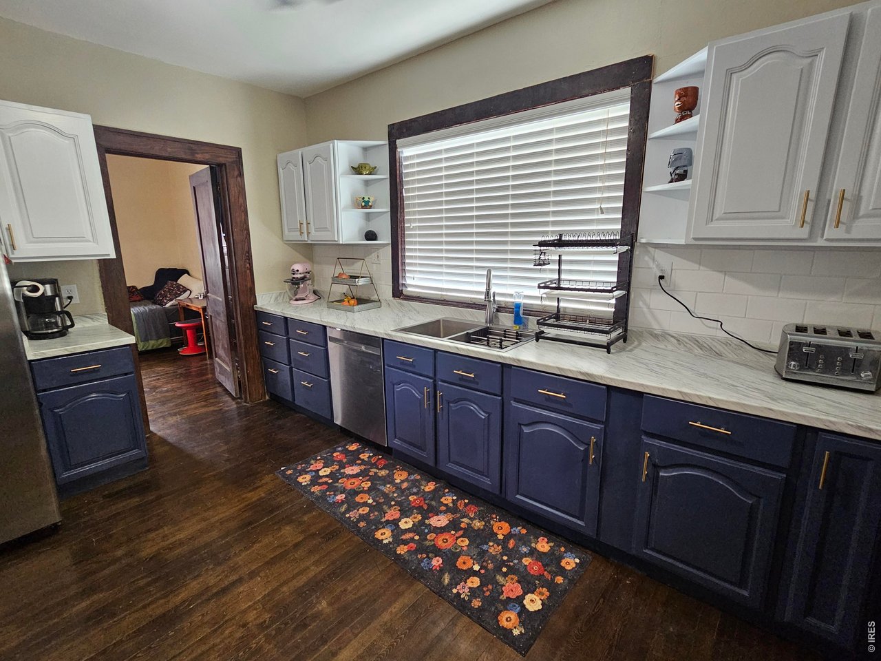 704 South 3rd Avenue Sterling, CO 80751 - Photo 12 of 33 Kitchen with doorway to the main level bedroom