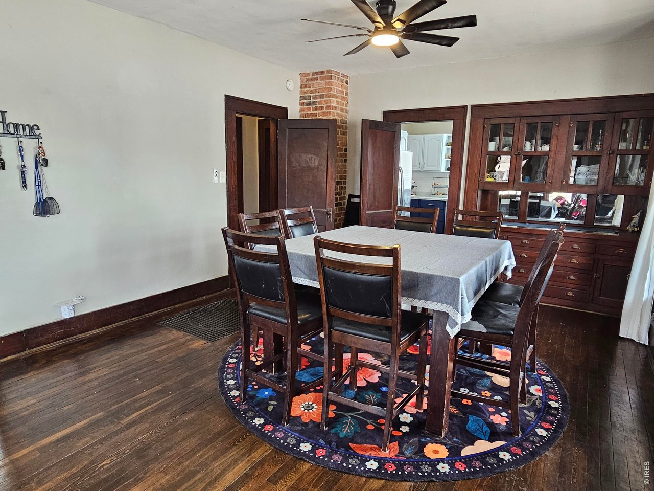 704 South 3rd Avenue Sterling, CO 80751 - Photo 6 of 33 Dining room with built-in hutch and exposed brick vent chimney