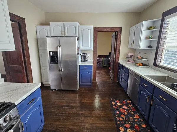 a kitchen with stainless steel appliances a refrigerator a sink a stove and cabinets