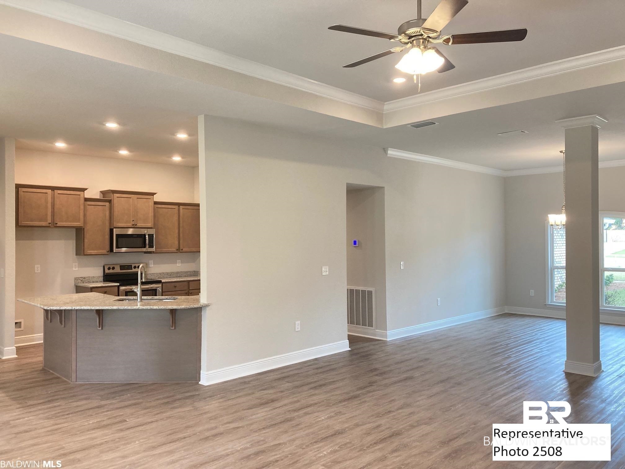 2201 Pollard Road Daphne, AL 36526 - Photo 3 of 15 Kitchen with appliances with stainless steel finishes, light stone counters, ceiling fan, and hardwood / wood-style floors
