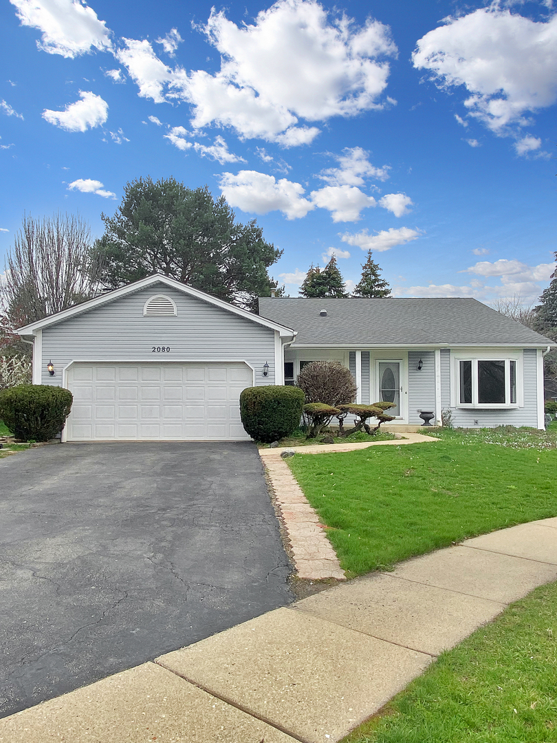 2080 Savannah Road Elgin, IL 60123 - Photo 1 of 17 a front view of a house with a garden and yard