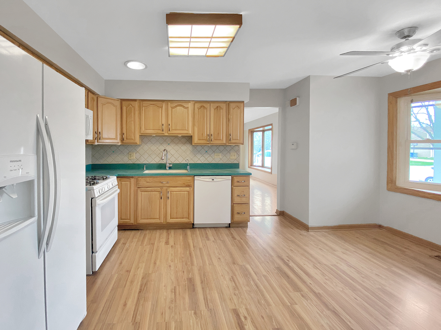 2080 Savannah Road Elgin, IL 60123 - Photo 5 of 17 a kitchen with stainless steel appliances granite countertop a refrigerator a sink dishwasher a stove and white countertops with wooden floor
