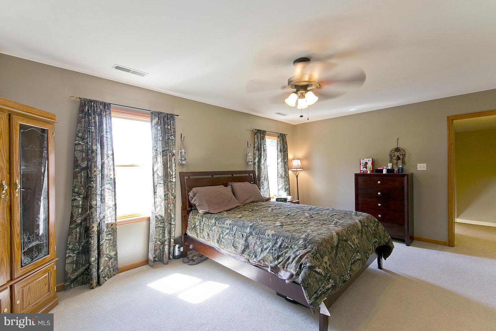 2000 South Pifer Road Star Tannery, VA 22654 - Photo 8 of 12 a bedroom with a bed and a chandelier
