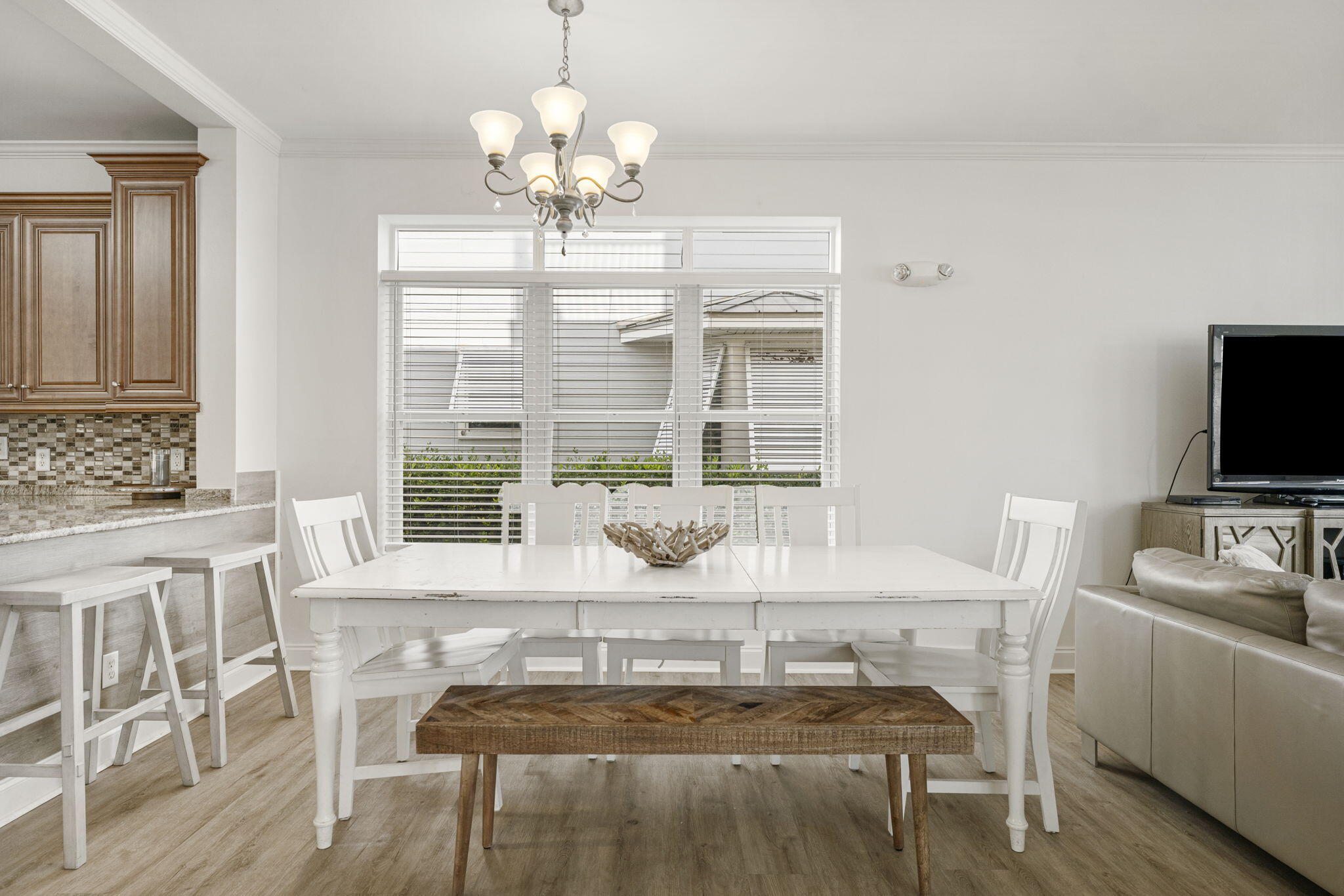 80 Shirah Street Destin, FL 32541 - Photo 22 of 66 a view of a dining room with furniture a chandelier and wooden floor