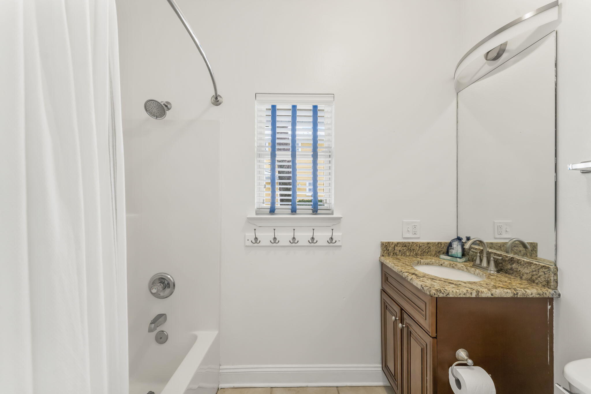80 Shirah Street Destin, FL 32541 - Photo 55 of 66 a bathroom with a granite countertop sink a mirror and a bathtub