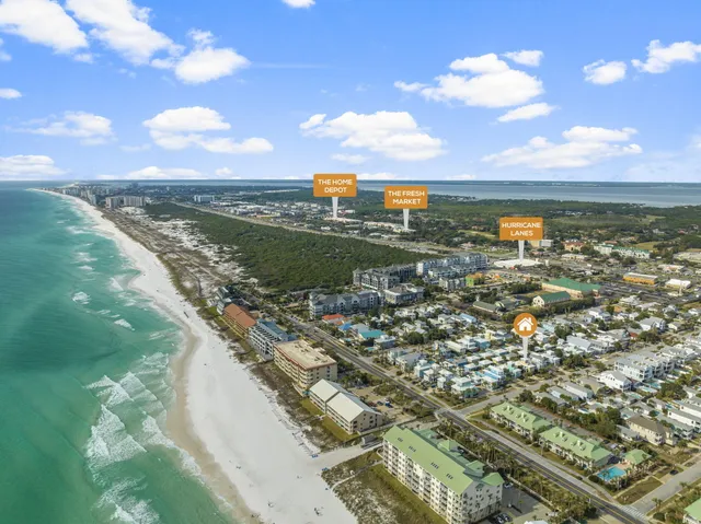 a view of a balcony dining area with a glass door and windows