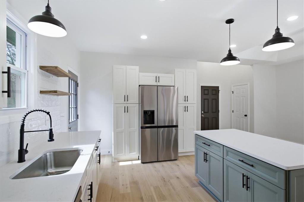 4911 Lower Jersey Road Oxford, GA 30054 - Photo 14 of 56 a kitchen with granite countertop a refrigerator and a sink