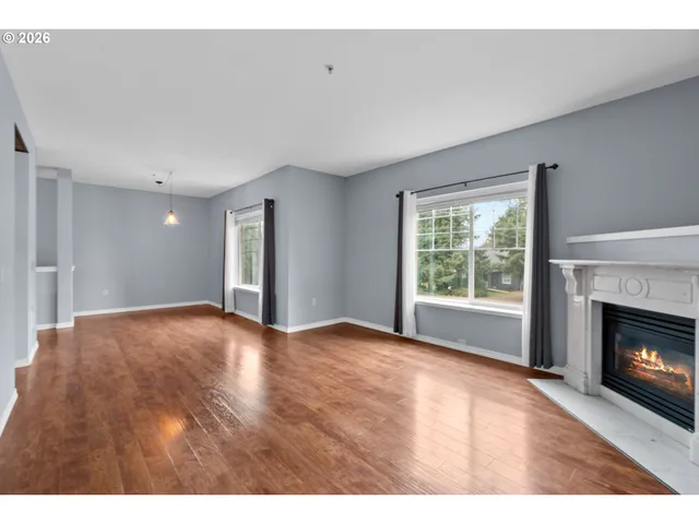 a view of an empty room with a fireplace