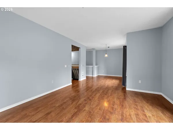 a view of an empty room and wooden floor