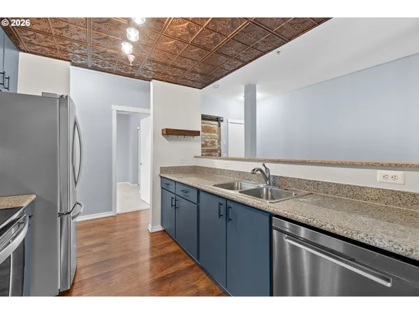 a kitchen with a sink and refrigerator