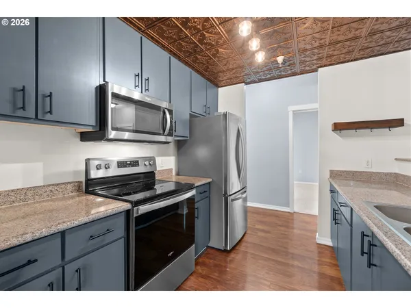 a kitchen with a stove microwave and refrigerator