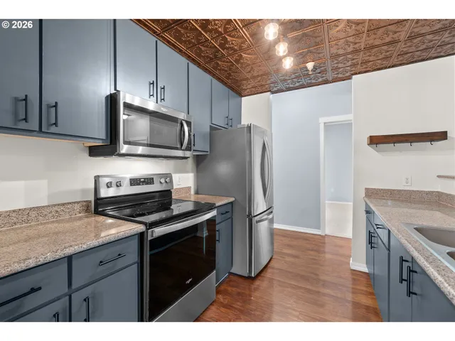a kitchen with a stove microwave and refrigerator