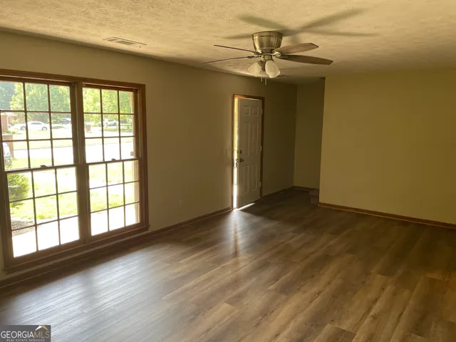 a view of entryway and hall with wooden floor