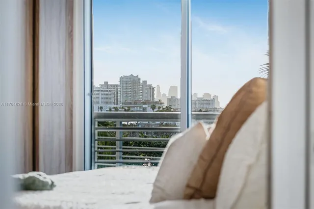 a view of a balcony with furniture and floor to ceiling window