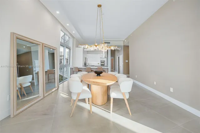 a dining room with furniture a chandelier and window