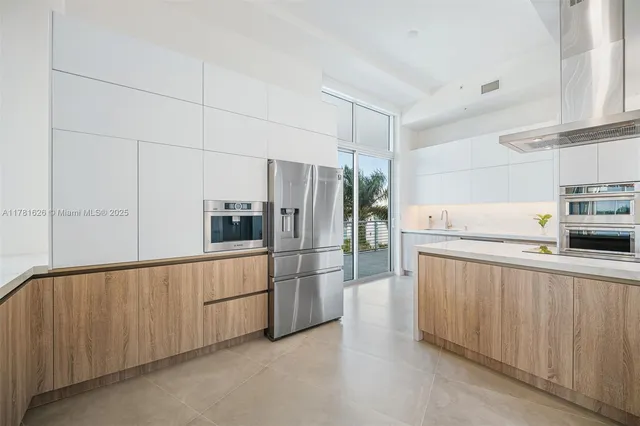 a kitchen with stainless steel appliances a refrigerator and a sink