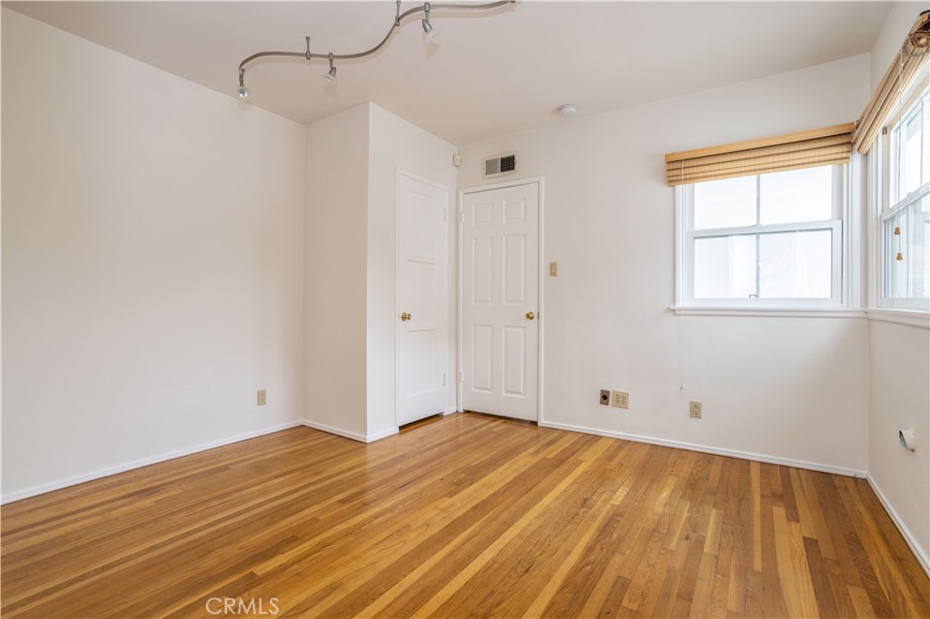 8129 Darby Place Reseda, CA 91335 - Photo 11 of 19 a view of empty room with wooden floor and fan