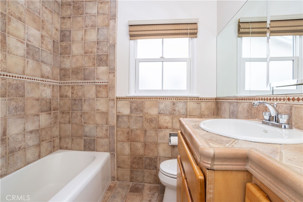 8129 Darby Place Reseda, CA 91335 - Photo 3 of 19 a bathroom with a sink a toilet and bathtub