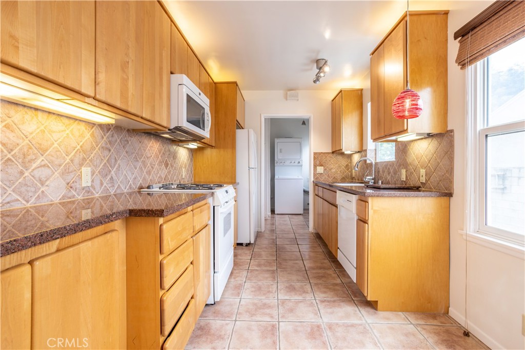 8129 Darby Place Reseda, CA 91335 - Photo 4 of 19 a kitchen with a sink stove and a refrigerator