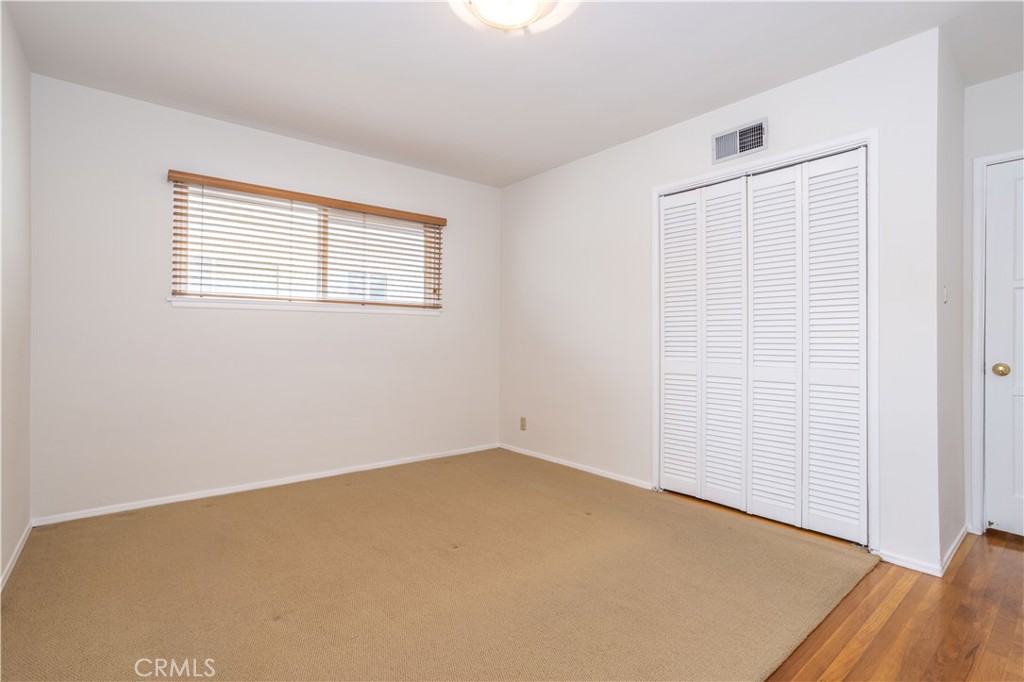 8129 Darby Place Reseda, CA 91335 - Photo 9 of 19 an empty room with wooden floor and windows