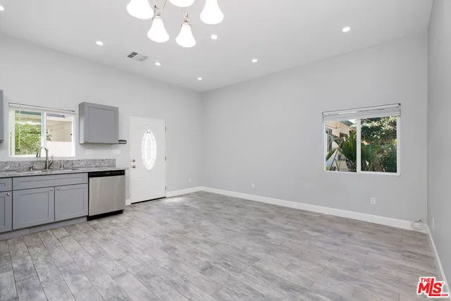 a kitchen with stainless steel appliances a refrigerator and a stove top oven