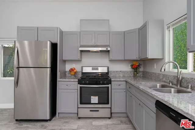 a view of a kitchen with a refrigerator and a microwave