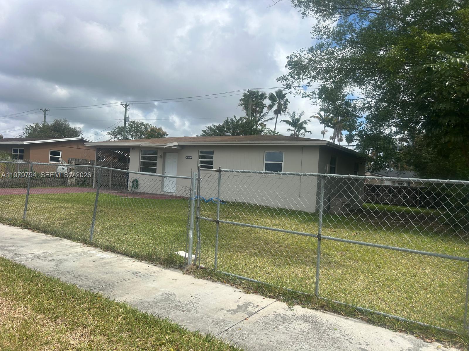 a view of a house with a backyard and a basket ball poll