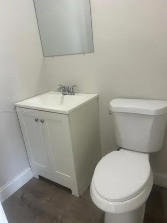 a white toilet sitting next to a bathroom sink