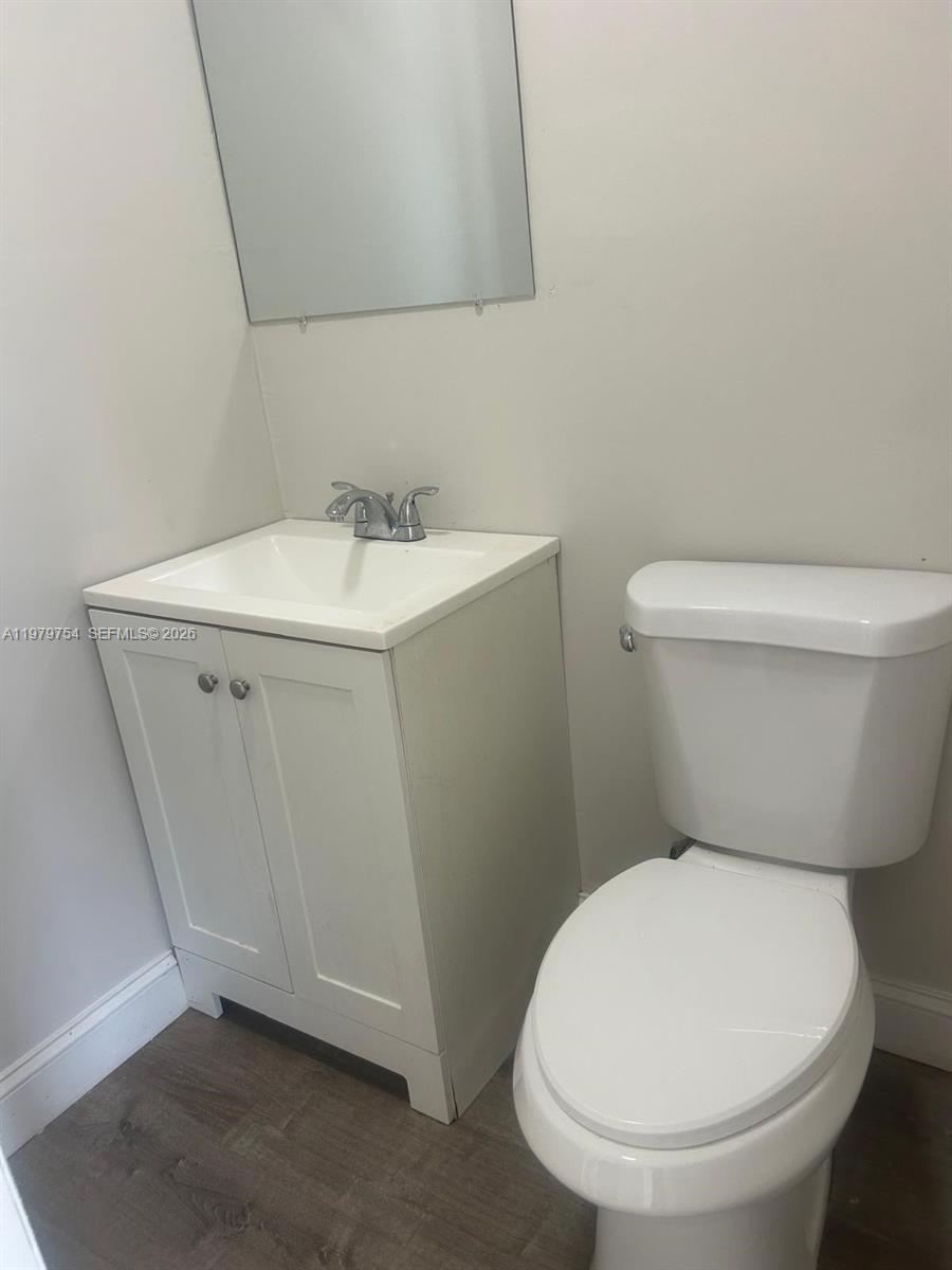 28511 Southwest 147th Avenue Homestead, FL 33033 - Photo 12 of 19 a white toilet sitting next to a bathroom sink