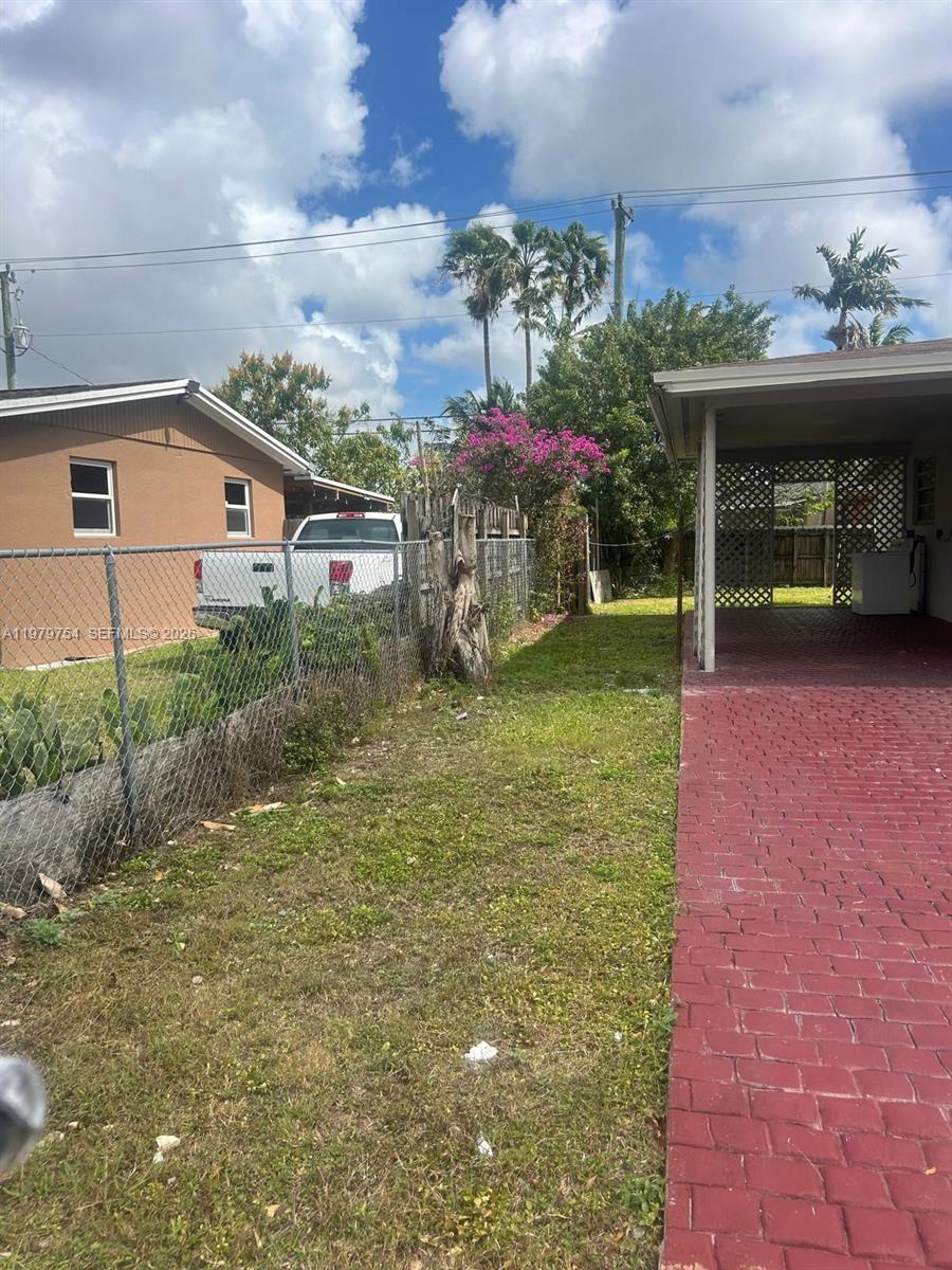 28511 Southwest 147th Avenue Homestead, FL 33033 - Photo 4 of 19 a view of a house with a porch and a yard