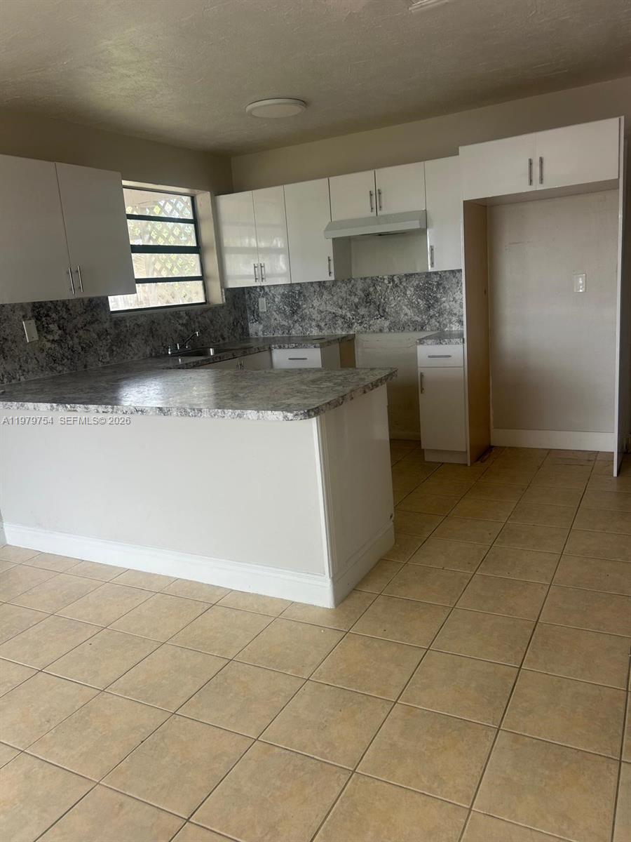 28511 Southwest 147th Avenue Homestead, FL 33033 - Photo 6 of 19 a kitchen with stainless steel appliances a sink a stove a microwave and a refrigerator