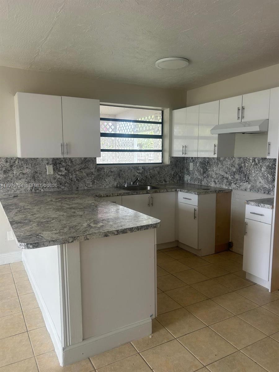 28511 Southwest 147th Avenue Homestead, FL 33033 - Photo 7 of 19 a kitchen with stainless steel appliances granite countertop a sink stove and cabinets