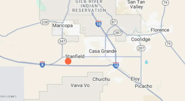 a street sign on a wall next to a road