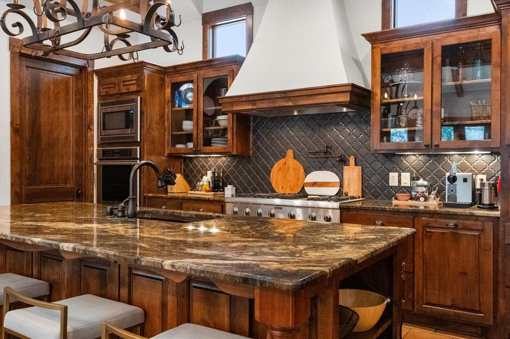 920 Nottingham Road Keller, TX 76248 - Photo 12 of 38 a kitchen with stainless steel appliances granite countertop a stove and cabinets