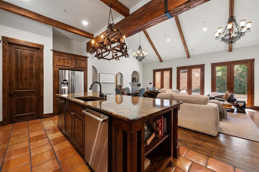920 Nottingham Road Keller, TX 76248 - Photo 14 of 38 a kitchen with counter top space dining table and stainless steel appliances