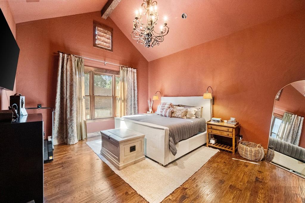 920 Nottingham Road Keller, TX 76248 - Photo 24 of 38 a spacious bedroom with a bed and a chandelier